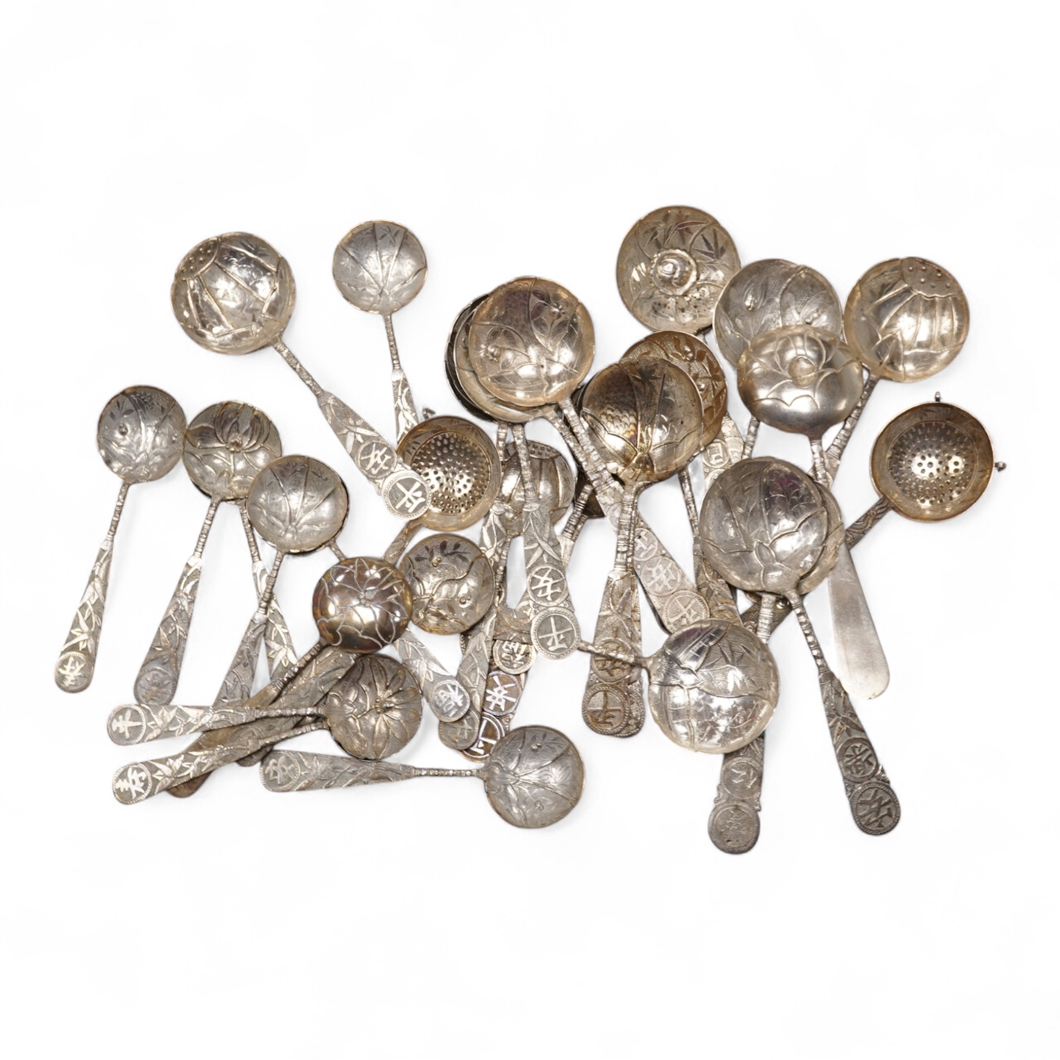 A set of twelve early 20th century Chinese Export white metal small spoons, maker LS, decorated with foliage and character mark, 10cm, a set of ten similar larger spoons, same maker, 12.3cm and another set a six similar